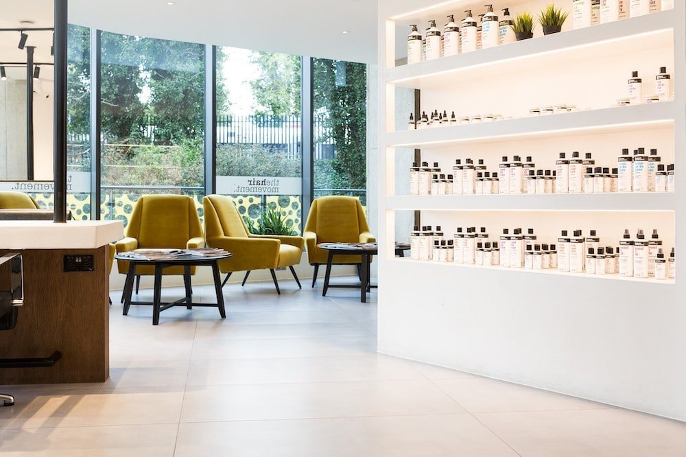 Industrial Retail Shelving made of white micro cement in Hair Movement Salon 