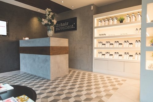 Concrete reception desk, concrete welcome wall, black concrete feature wall in hairdresser saloon